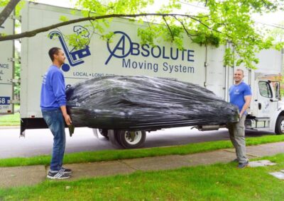 Pictured: moving professionals with a large piece of furniture.