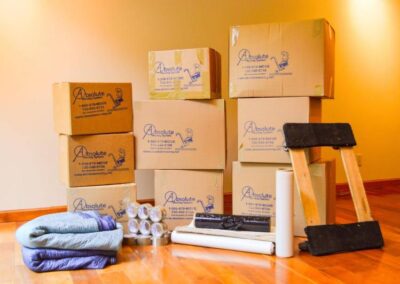 Pictured: Moving supplies such as some boxes, a furniture dolley, and furniture pads.